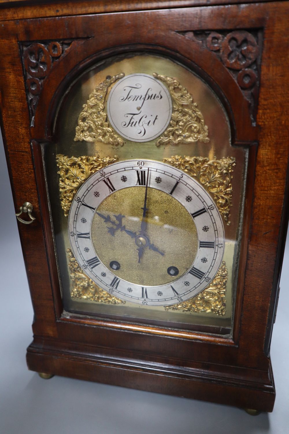 A George III-style mahogany mantel clock, 5.75 inch arched dial, gong striking movement, with key and pendulum, height 49cm